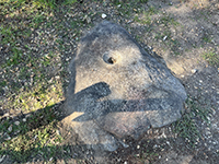 Indian mortar hole on a granite boulder.